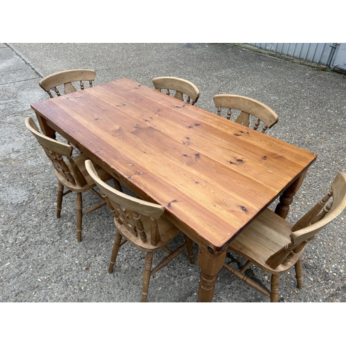 18 - A large farmhouse pine table together with a set of six country farmhouse pine chairs 184 x90x 78