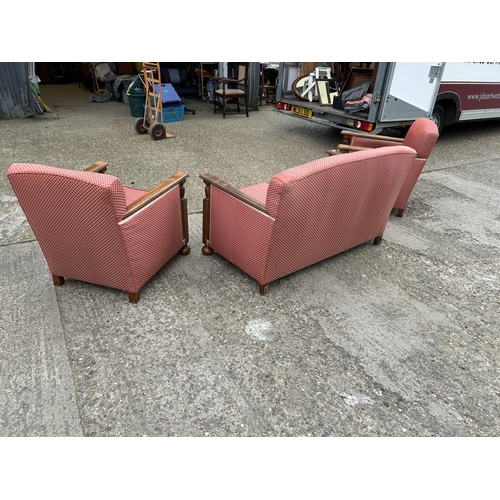 23 - An early 20th century oak framed three piece lounge suite consisting of two seater sofa with two cha... 