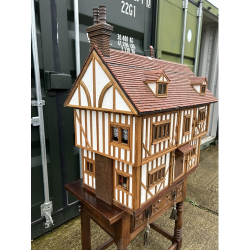 235 - A hand made Tudor style dolls house loaded with furnishings 90x50 x80