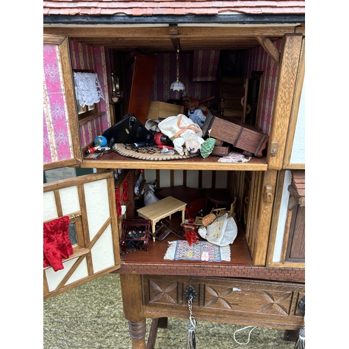 235 - A hand made Tudor style dolls house loaded with furnishings 90x50 x80