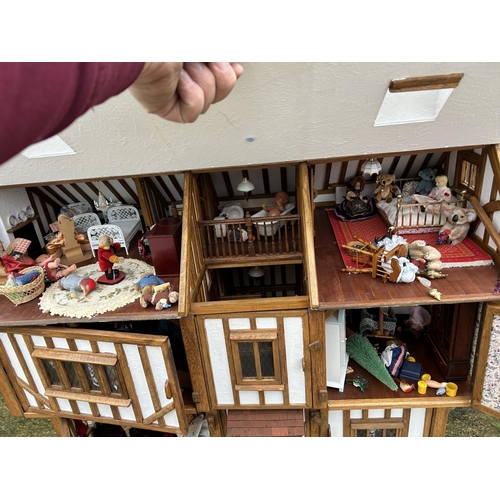 235 - A hand made Tudor style dolls house loaded with furnishings 90x50 x80