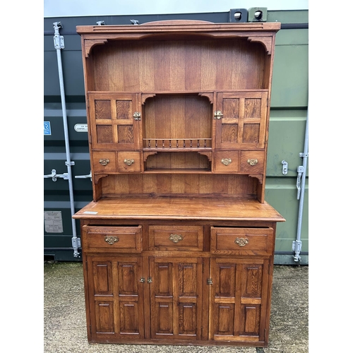 244 - A large oak Dresser with plate rack back and compartment top  136x48x216