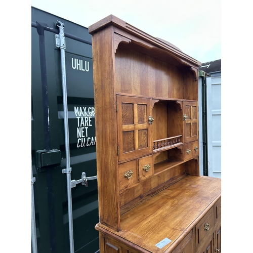 244 - A large oak Dresser with plate rack back and compartment top  136x48x216