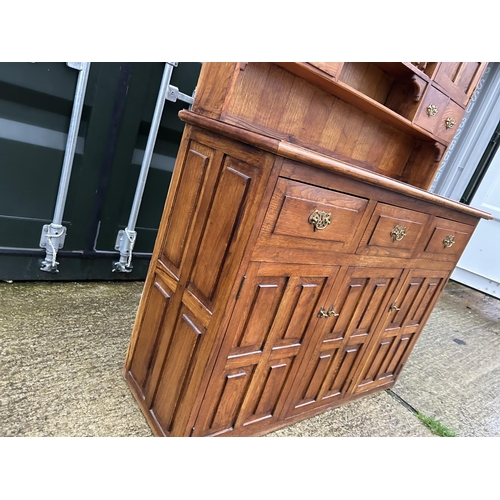 244 - A large oak Dresser with plate rack back and compartment top  136x48x216