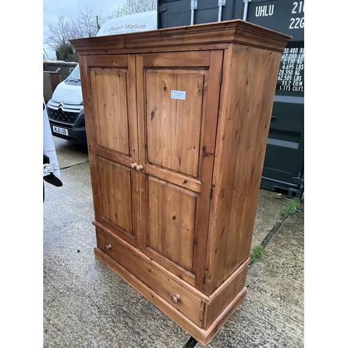 251 - A small pine wardrobe with drawer