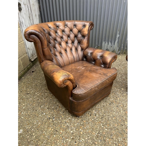 26 - A brown leather chesterfield two seater sofa together with a matching armchair (chair af to arm)