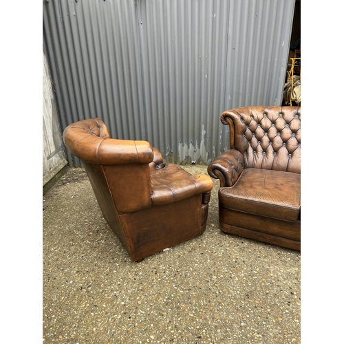 26 - A brown leather chesterfield two seater sofa together with a matching armchair (chair af to arm)
