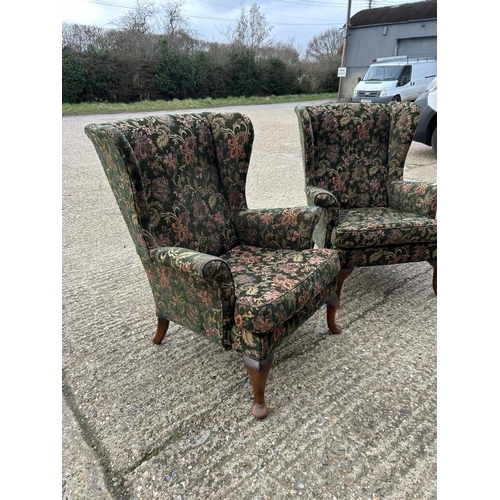 28 - A pair of green upholstered wing back chairs by PARKER KNOLL