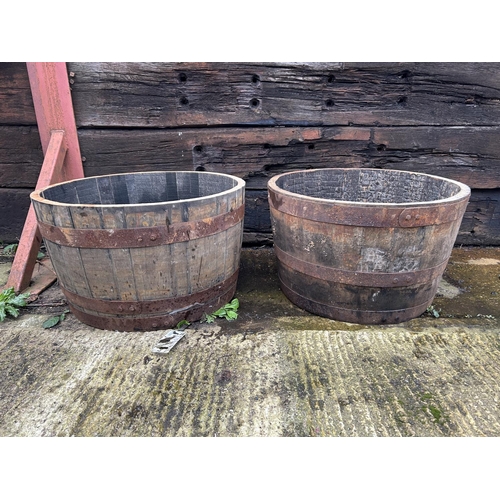 317 - A pair of Scottish oak half whisky barrel planters 2ft round