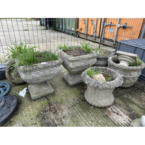 348 - A collection of concrete planters including two on plinths, pair of circular etc