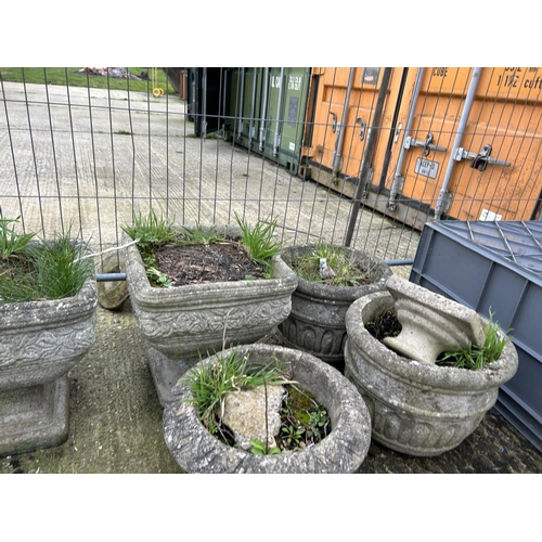 348 - A collection of concrete planters including two on plinths, pair of circular etc