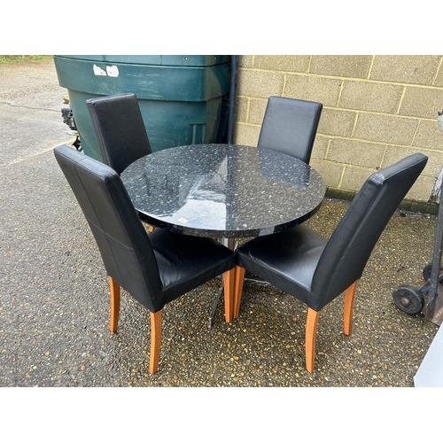 64 - A modern marble effect circular kitchen table together with four leather high back chairs 110cm