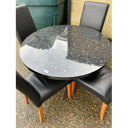 64 - A modern marble effect circular kitchen table together with four leather high back chairs 110cm