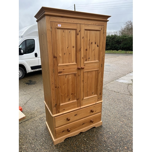 66 - A solid pine double wardrobe with 2 drawers, fitted to the inside with shelves 96x50x198