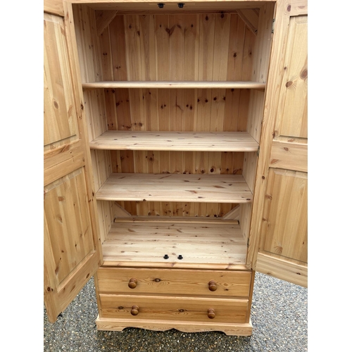 66 - A solid pine double wardrobe with 2 drawers, fitted to the inside with shelves 96x50x198