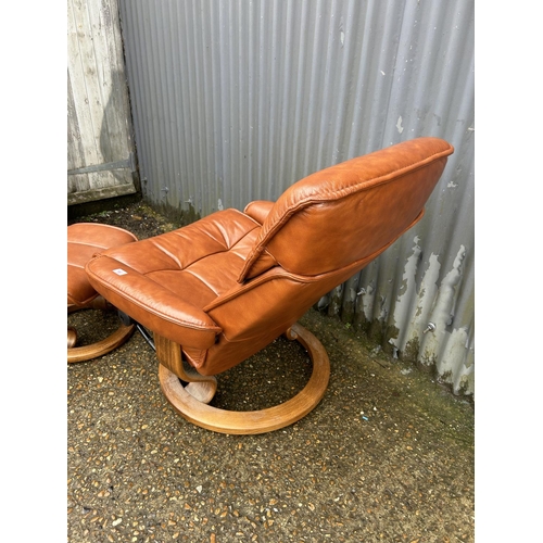 84 - A tan brown leather EKORNES stressless recliner chair with stool