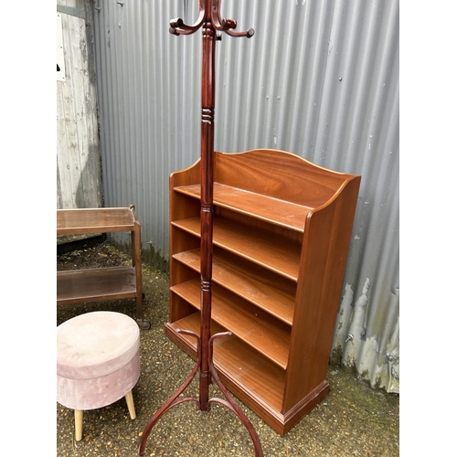 85 - A teak Parker knoll bookcase with oak trolley, pink stool and coat hooks