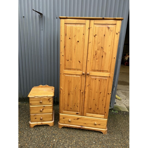 88 - A pine double wardrobe together with matching three drawer bedside