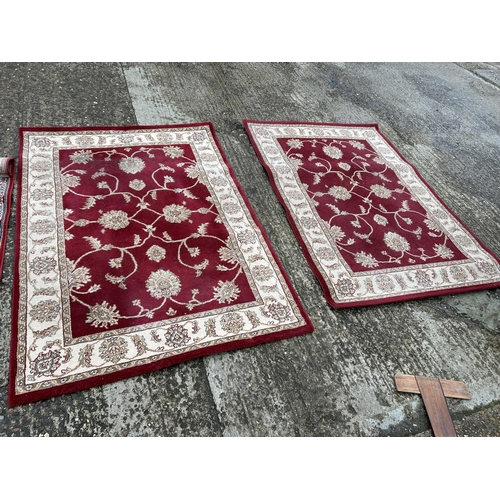 99 - Four red pattern rugs larger 170x120