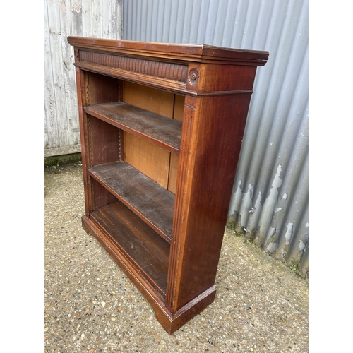 104 - A mahogany open fronted bookcase with three adjustable shelves 90x30x110