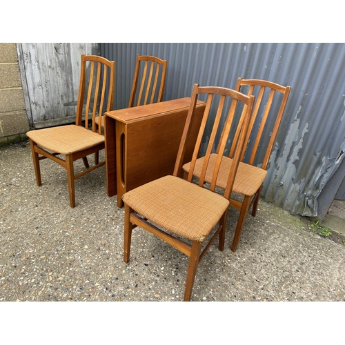 119 - A mid century teak gate-leg table together with four chairs