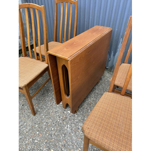 119 - A mid century teak gate-leg table together with four chairs