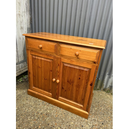 129 - A solid pine two drawer sideboard