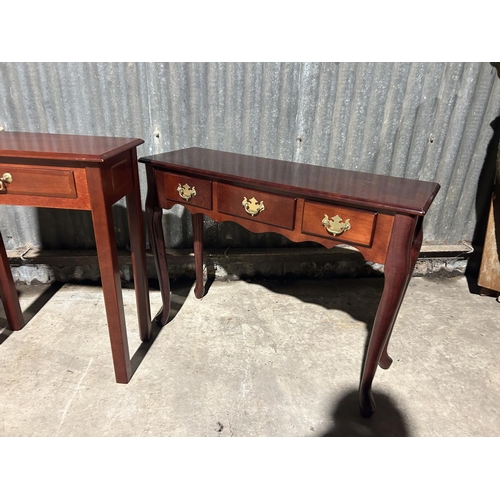 13 - A reproduction three drawer hall table together with single drawer table and leather top table