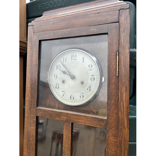 133 - A modern pine long case clock together with an oak cased long-case clock