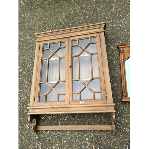 134 - A large pine wall cabinet together with a pine framed mirror