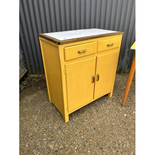 150 - A yellow painted kitchen cupboard together with a yellow formica kitchen table