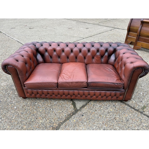 165 - A red leather chesterfield three seater sofa