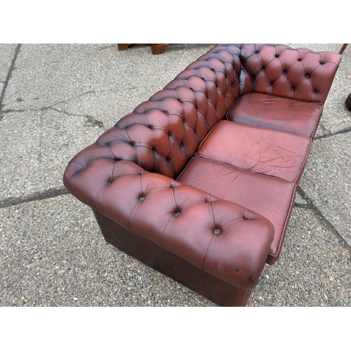 165 - A red leather chesterfield three seater sofa