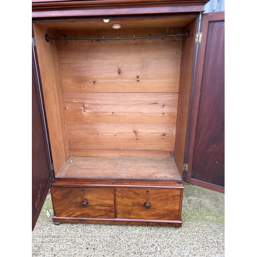 171 - A large Victorian mahogany wardrobe with full length hanging over two Deep drawers  133x53x207