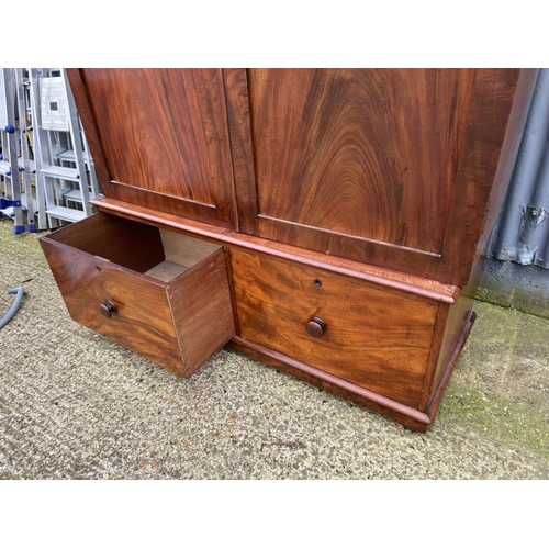 171 - A large Victorian mahogany wardrobe with full length hanging over two Deep drawers  133x53x207