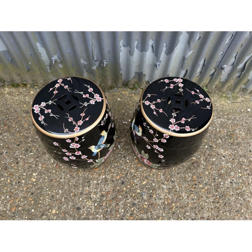 176 - A pair of Oriental ceramic garden seats decorated with bird patterns