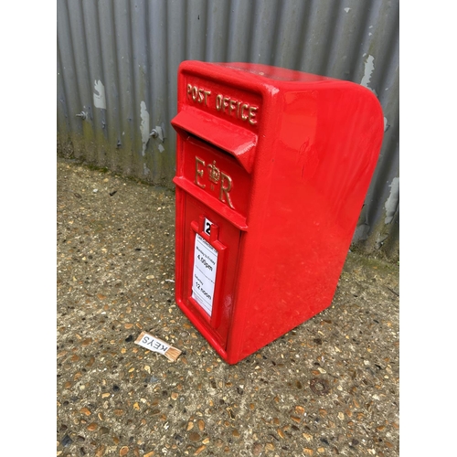 177 - A reproduction red iron letter box with two keys 67cm tall