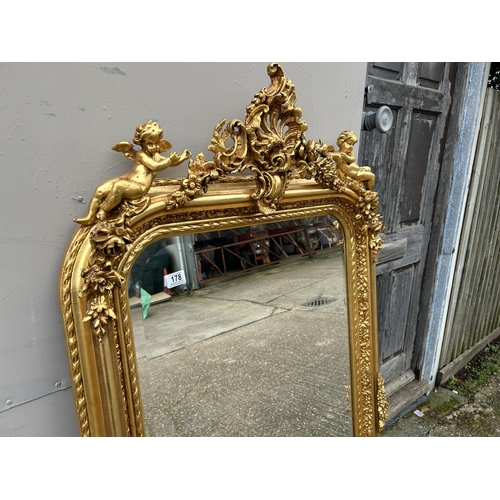 178 - A large gold gilt wall mirror with cherub decoration 85x160