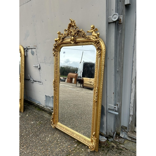 178 - A large gold gilt wall mirror with cherub decoration 85x160