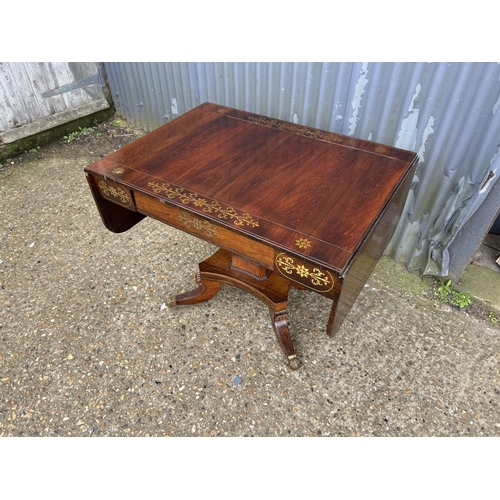 182 - A regency rosewood sofa table with a single drawer and brass inlay