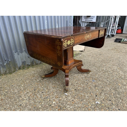 182 - A regency rosewood sofa table with a single drawer and brass inlay