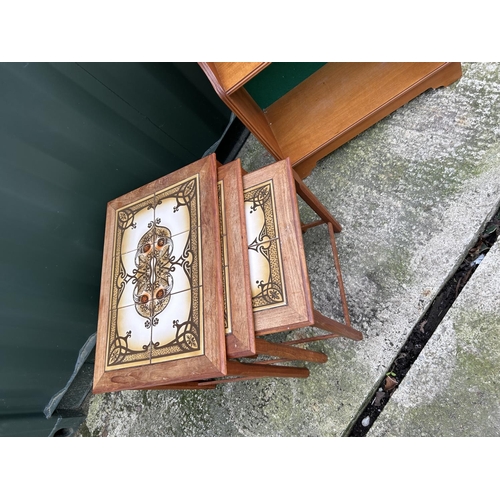 198 - A teak nest of three tables together with a teak waterfall front bookcase