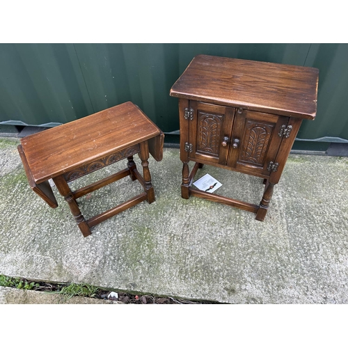 209 - A carved oak cupboard together with a matching drop leaf table