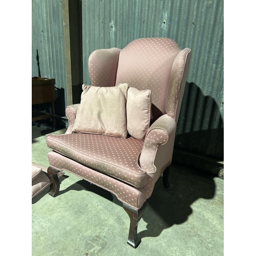 21 - A pink upholstered wing back armchair with 4 cushions