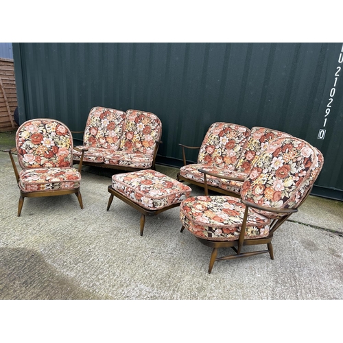 221 - An Ercol dark elm five piece lounge suite consisting two sofas, one chair and a footstool