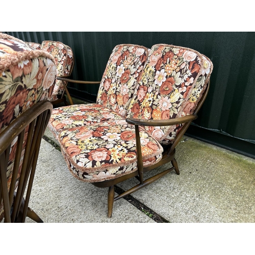 221 - An Ercol dark elm five piece lounge suite consisting two sofas, one chair and a footstool