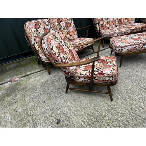 221 - An Ercol dark elm five piece lounge suite consisting two sofas, one chair and a footstool