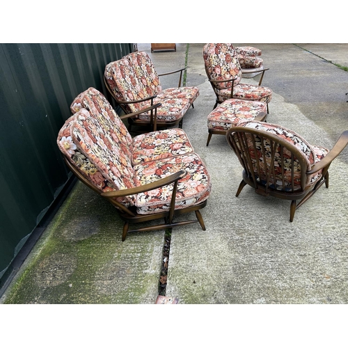 221 - An Ercol dark elm five piece lounge suite consisting two sofas, one chair and a footstool