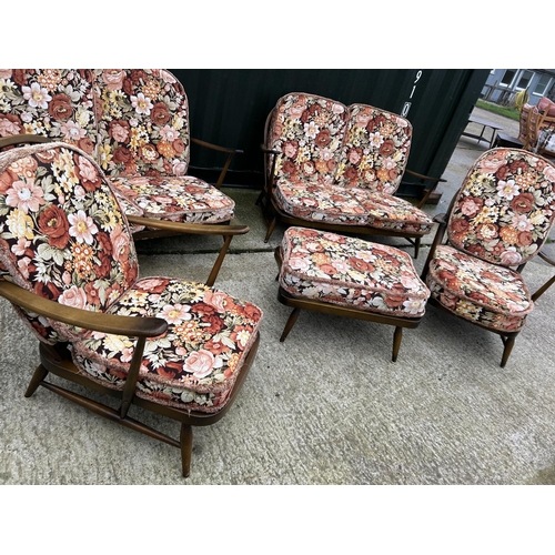 221 - An Ercol dark elm five piece lounge suite consisting two sofas, one chair and a footstool