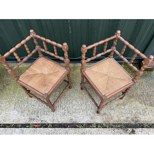 228 - A pair of rush seat corner chairs